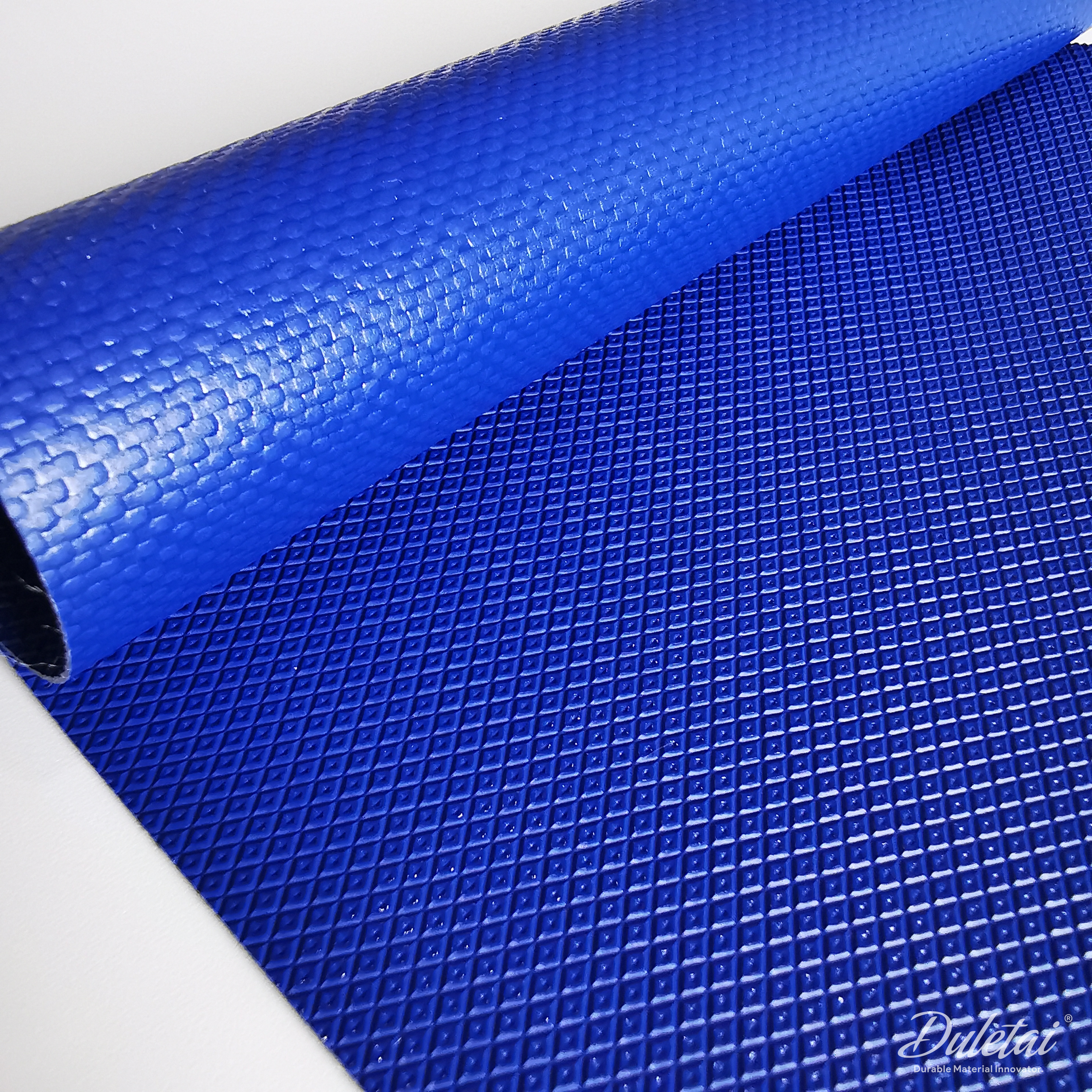 DLT-5153-main-duletai Blue heavy duty PVC tarp fabric DLT-5153 showing coated and embossed surfaces, 1000gsm