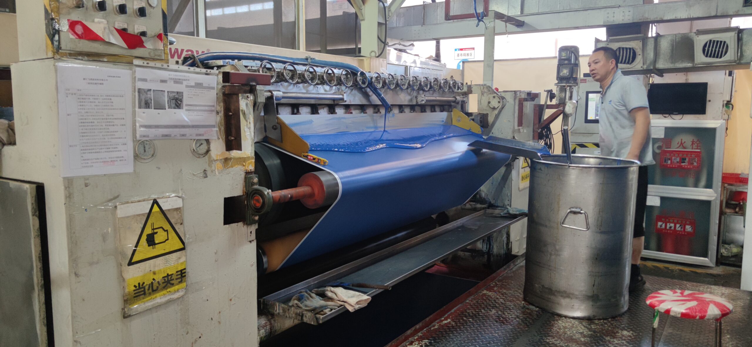 PVC knife-coating line applying blue coating to fabric