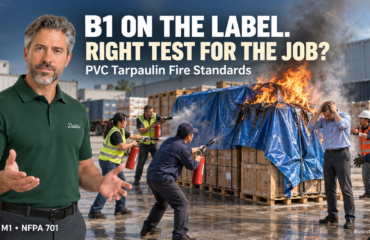 PVC Tarpaulin Fire Standards — B1 on the label, right test for the job? Illustrative cargo-fire scene for PVC tarpaulin fire standards: Duletai presenter, burning tarp-covered goods, extinguisher responders and a regretful buyer. B1 on the label. Right test for the job?